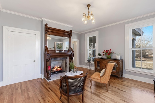 living area featuring a fireplace, a notable chandelier, plenty of natural light, and light wood-type flooring