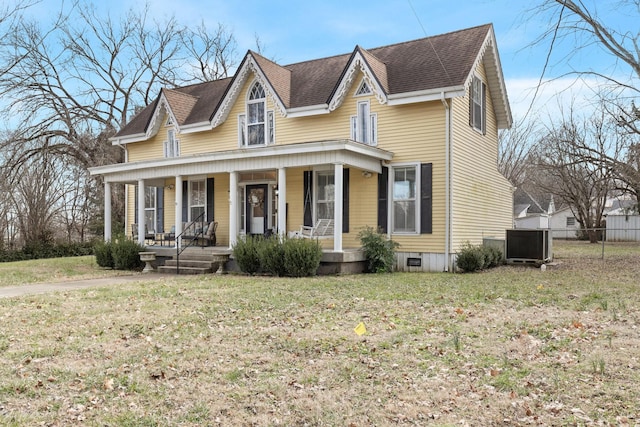 view of front of property featuring a porch, a front yard, and central air condition unit