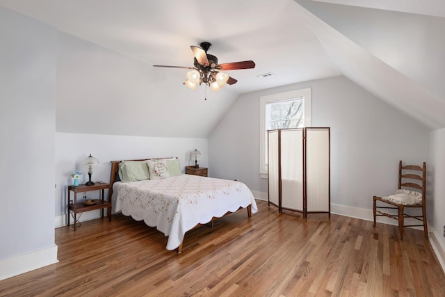 bedroom featuring lofted ceiling, wood-type flooring, and ceiling fan