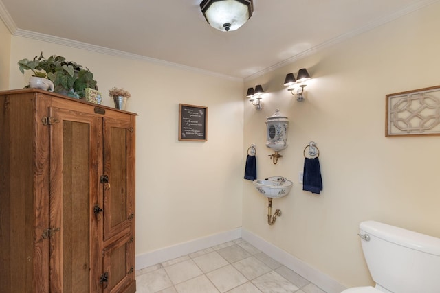 bathroom featuring tile patterned flooring, ornamental molding, and toilet