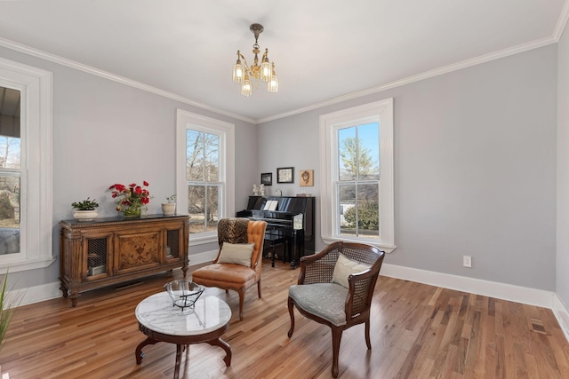 sitting room featuring hardwood / wood-style floors, crown molding, and a wealth of natural light