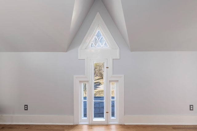 interior space with wood-type flooring and high vaulted ceiling