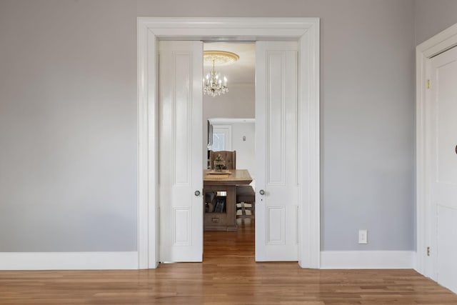 interior space featuring hardwood / wood-style floors and a chandelier