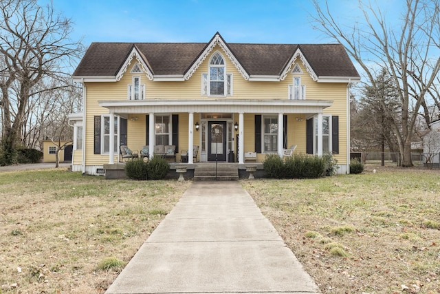 view of front facade with a porch and a front lawn