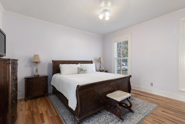 bedroom featuring wood-type flooring, ornamental molding, and ceiling fan