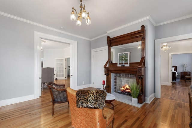 living area with an inviting chandelier, wood-type flooring, and ornamental molding