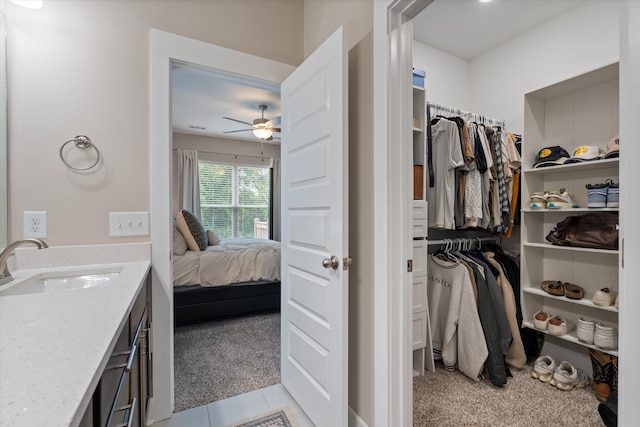 bathroom featuring ceiling fan, vanity, and tile patterned flooring