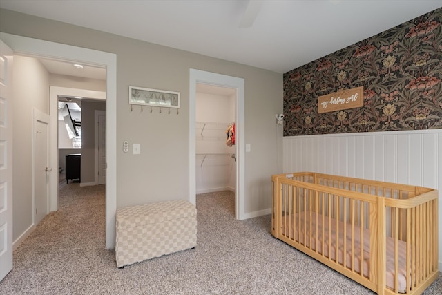 bedroom with a walk in closet and carpet flooring