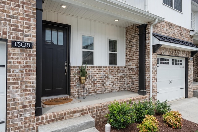 view of exterior entry with a garage and a porch