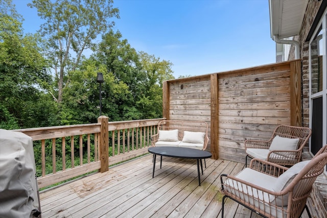 wooden deck featuring a grill