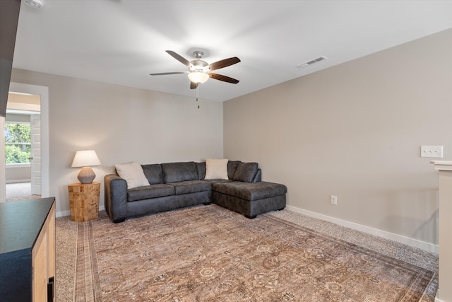 living room featuring carpet and ceiling fan