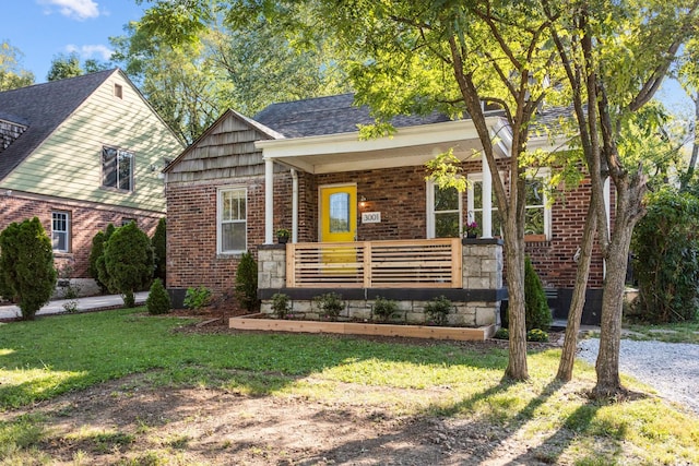 view of front of property with a front yard and covered porch