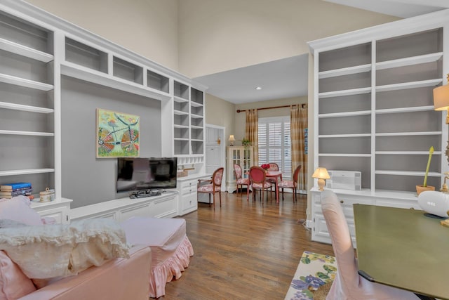 living room with dark wood-style flooring and a wall unit AC