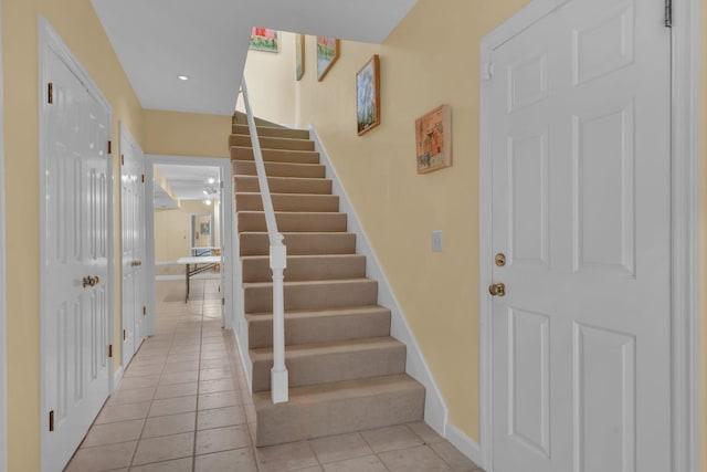 stairs featuring tile patterned flooring and baseboards