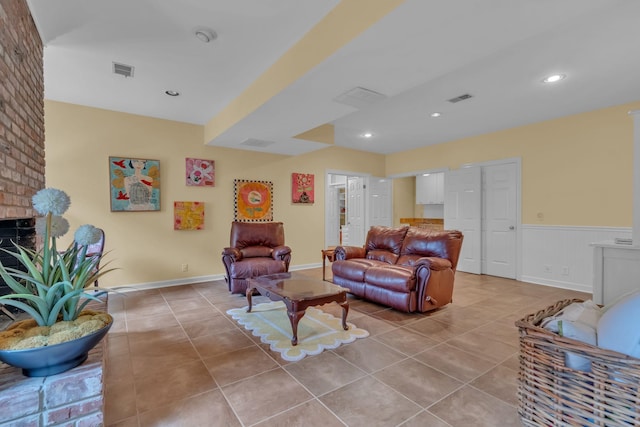 tiled living room featuring a fireplace