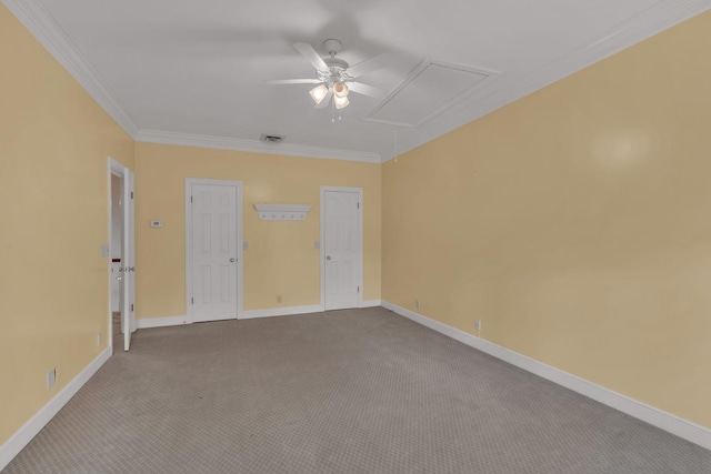 empty room featuring crown molding, baseboards, attic access, and light colored carpet