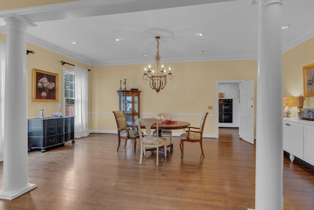 dining space with crown molding, decorative columns, dark hardwood / wood-style floors, and a chandelier