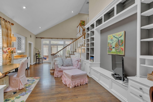 living room with high vaulted ceiling and dark hardwood / wood-style flooring