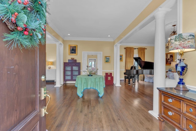 entrance foyer with decorative columns, wood-type flooring, and crown molding