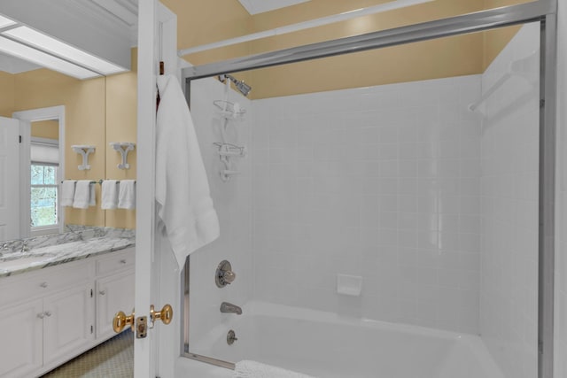 bathroom featuring vanity, tiled shower / bath combo, and a skylight