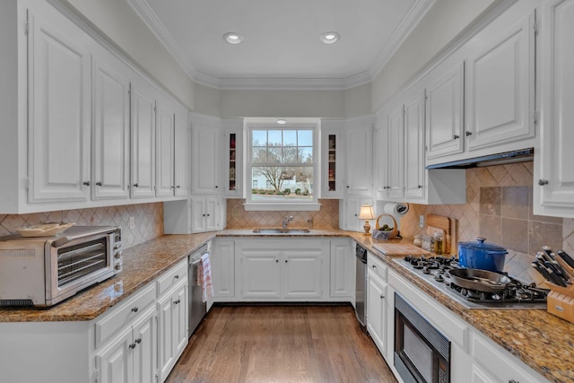 kitchen with stainless steel appliances, white cabinetry, and sink