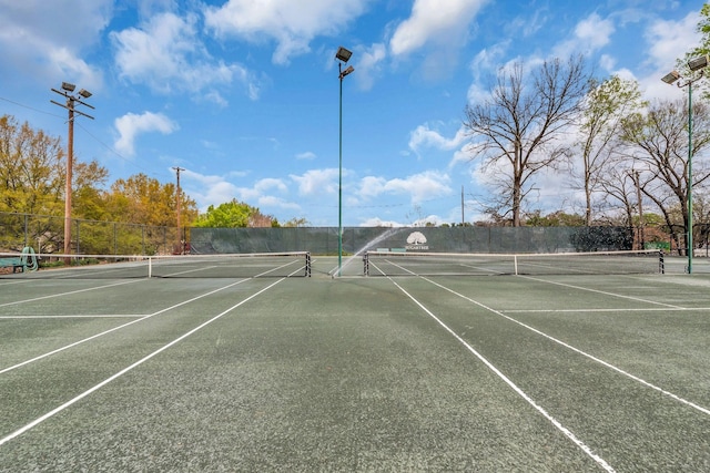 view of sport court featuring fence