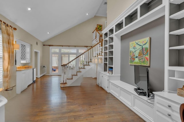 interior space featuring stairs, high vaulted ceiling, wood finished floors, and recessed lighting