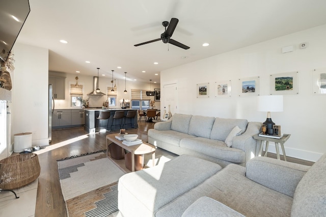 living room featuring ceiling fan and light wood-type flooring