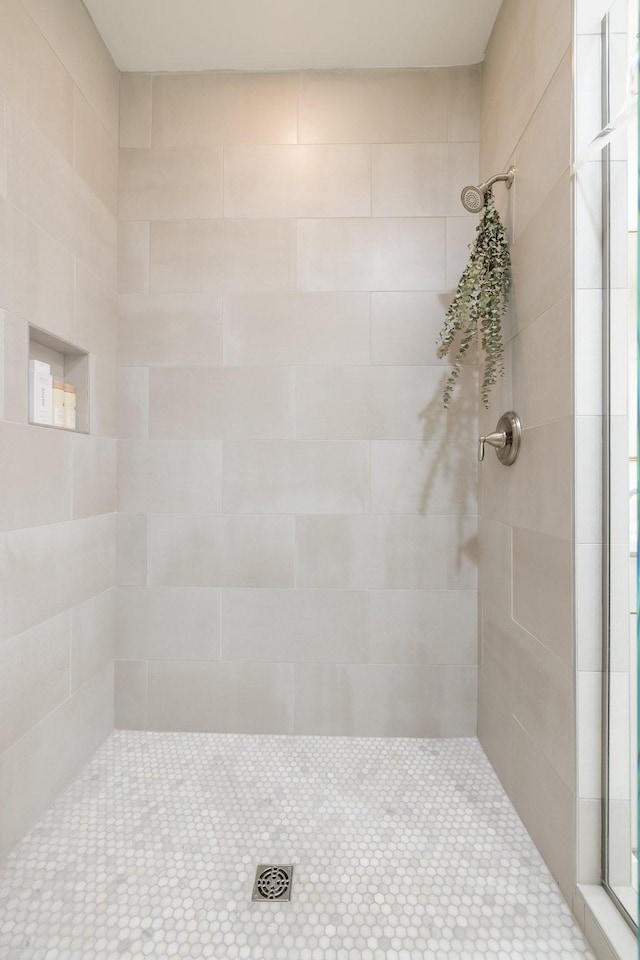 bathroom with a tile shower