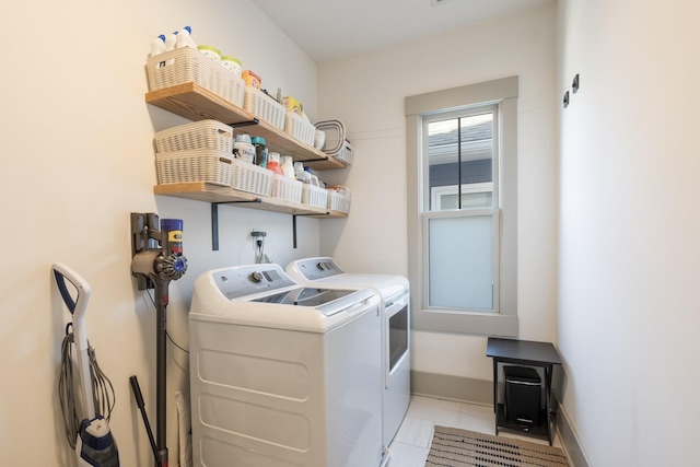 clothes washing area with light tile patterned floors and independent washer and dryer