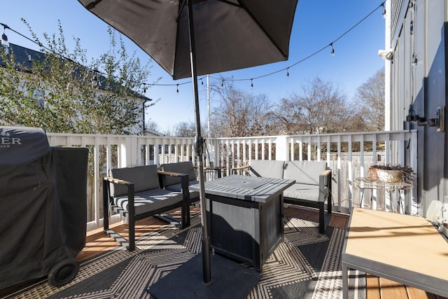 wooden terrace with an outdoor hangout area