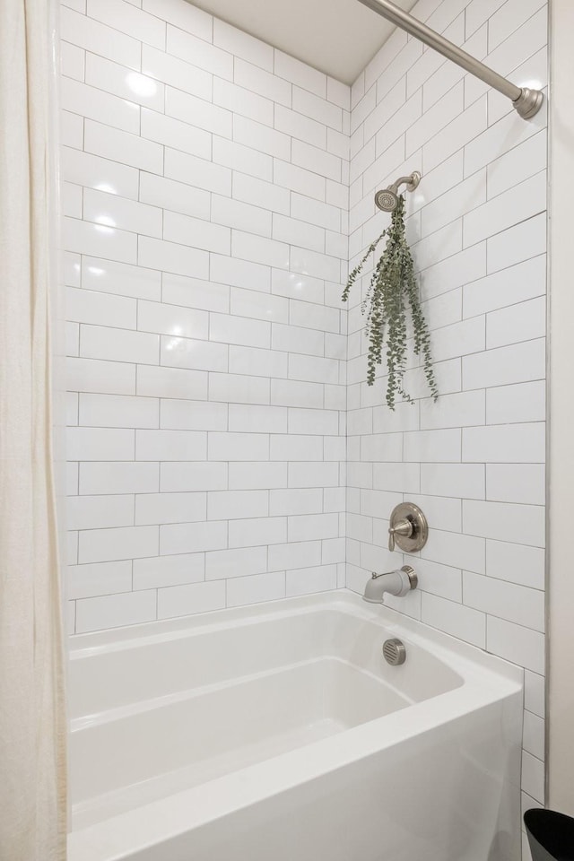 bathroom with shower / bath combo with shower curtain