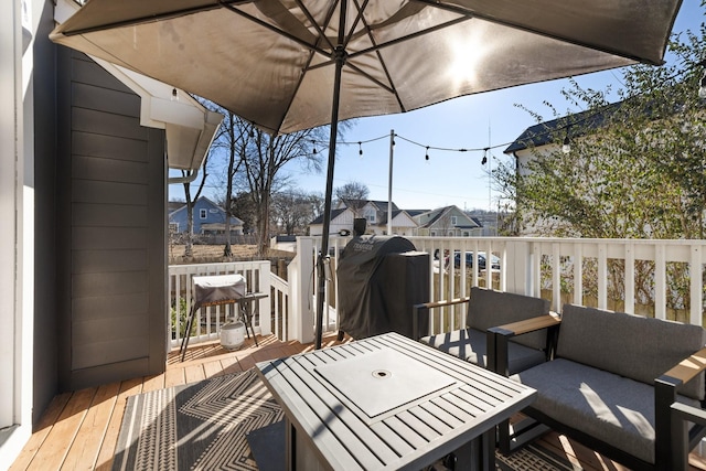 wooden deck with a grill