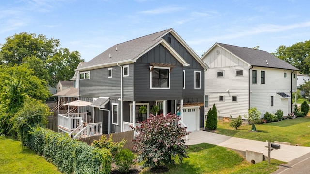 back of house featuring a yard and a garage