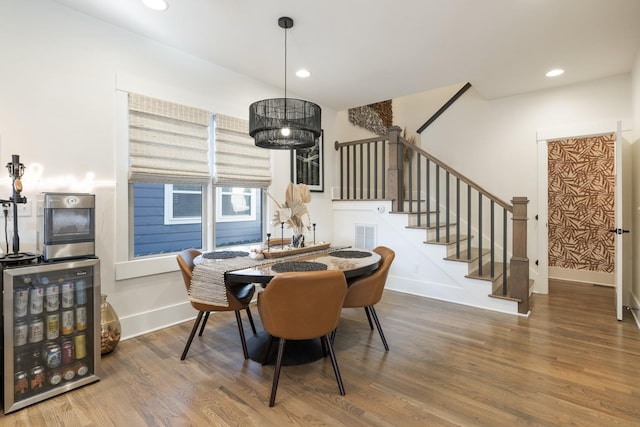 dining space with wood-type flooring