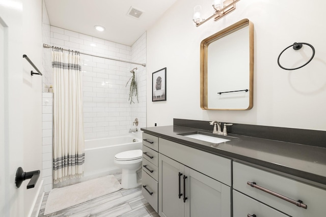 full bathroom featuring shower / tub combo with curtain, vanity, and toilet