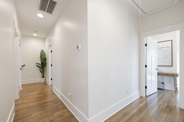 hallway with hardwood / wood-style floors