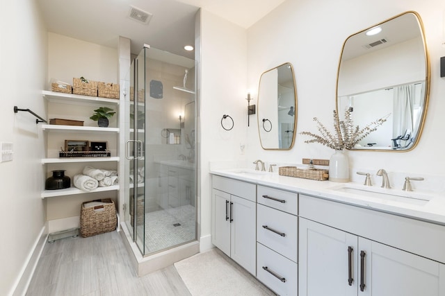 bathroom featuring walk in shower and vanity