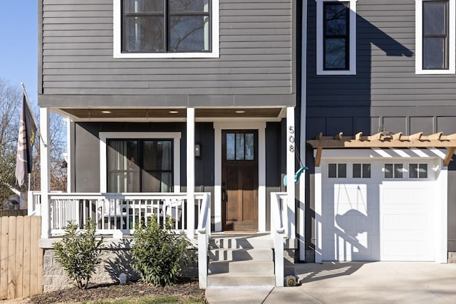 doorway to property featuring a garage and covered porch