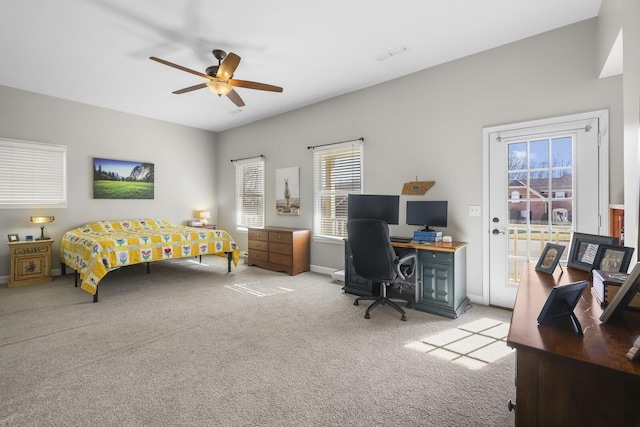 bedroom with ceiling fan, access to exterior, and light carpet