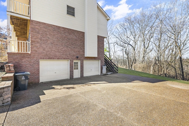 view of side of home featuring a garage