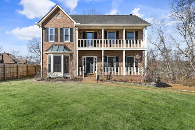 view of front of house with a front lawn, a balcony, and covered porch