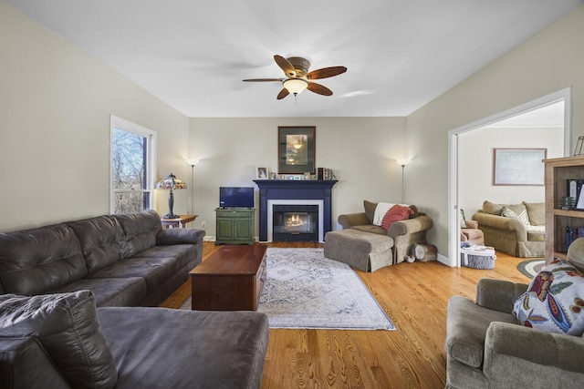 living room with hardwood / wood-style flooring and ceiling fan