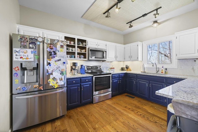 kitchen featuring sink, light hardwood / wood-style flooring, white cabinetry, stainless steel appliances, and blue cabinets