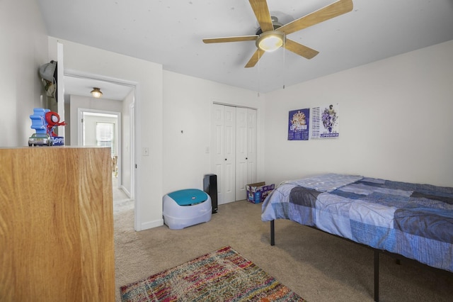 carpeted bedroom featuring a closet and ceiling fan