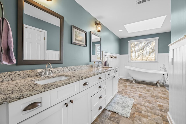 bathroom with vanity and a tub to relax in