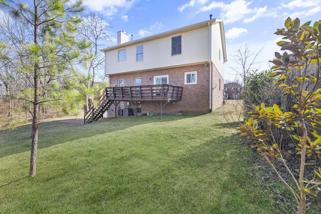 rear view of house with a wooden deck, a yard, and cooling unit