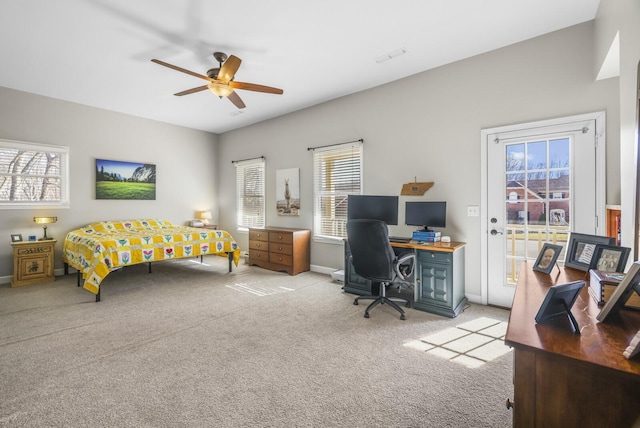 carpeted bedroom with ceiling fan and access to outside