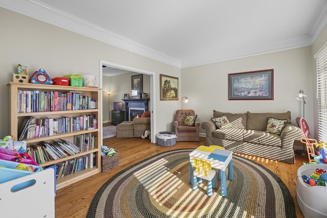 living room with wood-type flooring and ornamental molding