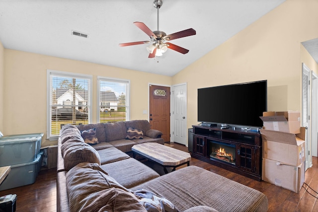 living room featuring dark wood-type flooring, ceiling fan, and vaulted ceiling